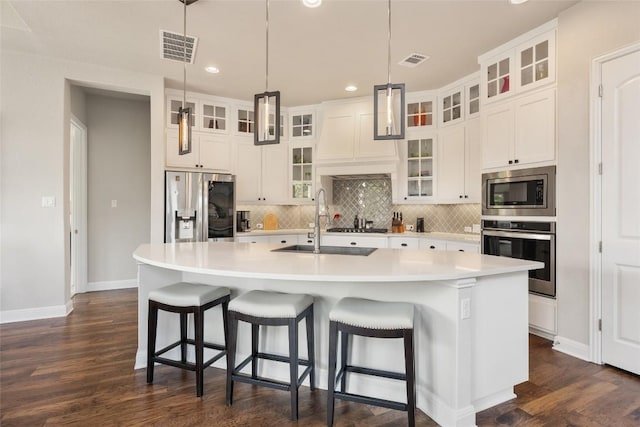 105 Curacao Ct, Austin, TX 78738 - kitchen with appliances with stainless steel finishes, dark wood-style flooring, recessed lighting, backsplash, and light countertops