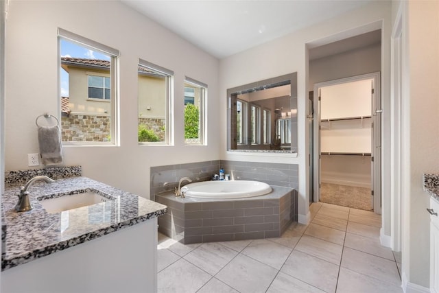 105 Curacao Ct, Austin, TX 78738 - bathroom featuring vanity, healthy amount of natural light, a garden tub, and tile patterned flooring