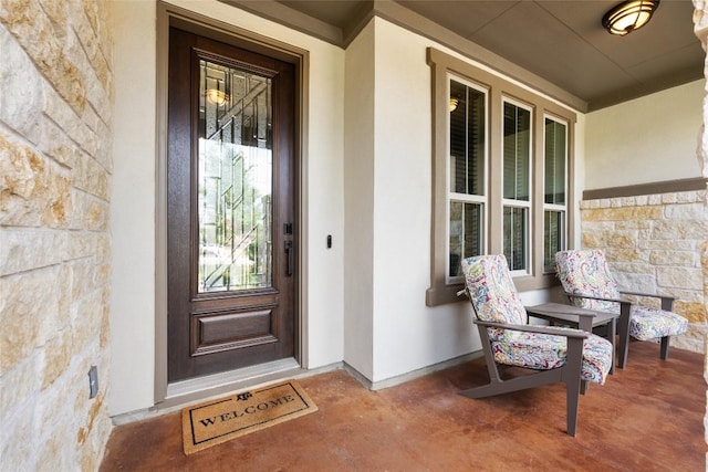 105 Curacao Ct, Austin, TX 78738 - doorway to property featuring stone siding, a porch, and stucco siding