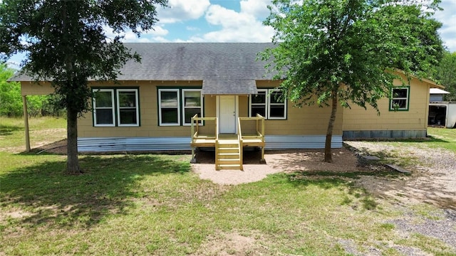 121 Wyers Pl, Cedar Creek, TX 78612 - view of front of house featuring a shingled roof and a front lawn