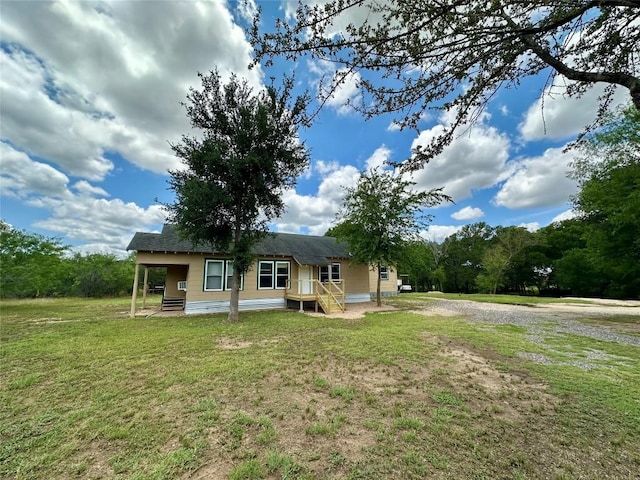 121 Wyers Pl, Cedar Creek, TX 78612 - back of house with a lawn