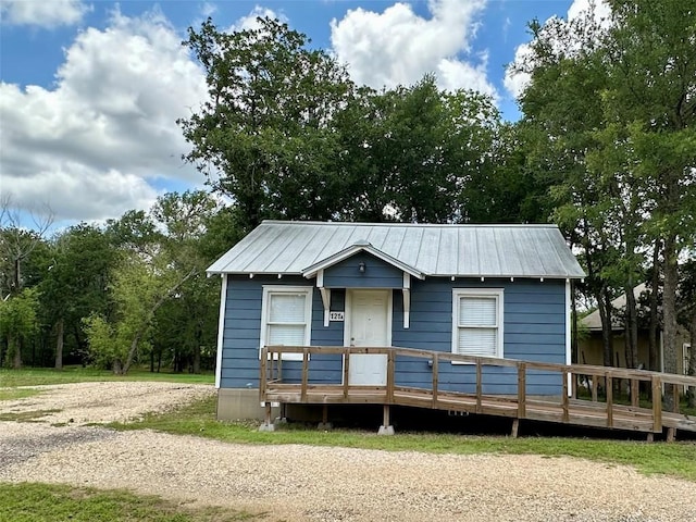121 Wyers Pl, Cedar Creek, TX 78612 - view of front of home with a metal roof and a deck