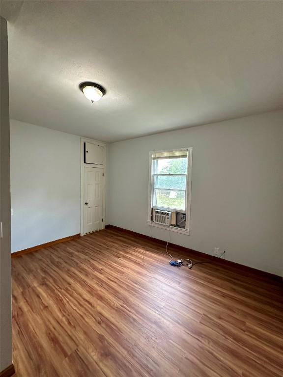 121 Wyers Pl, Cedar Creek, TX 78612 - empty room featuring wood finished floors and cooling unit