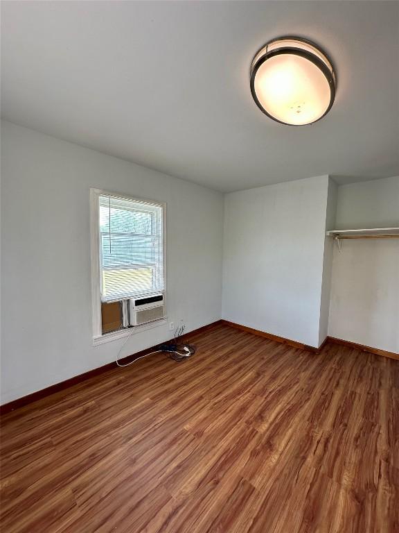 121 Wyers Pl, Cedar Creek, TX 78612 - unfurnished bedroom featuring wood finished floors, cooling unit, and a closet