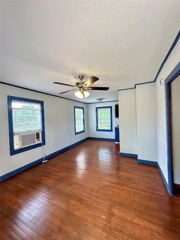121 Wyers Pl, Cedar Creek, TX 78612 - unfurnished bedroom featuring wood finished floors, a textured ceiling, and a ceiling fan