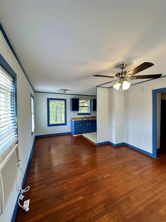 121 Wyers Pl, Cedar Creek, TX 78612 - unfurnished living room featuring dark wood-style floors and a ceiling fan