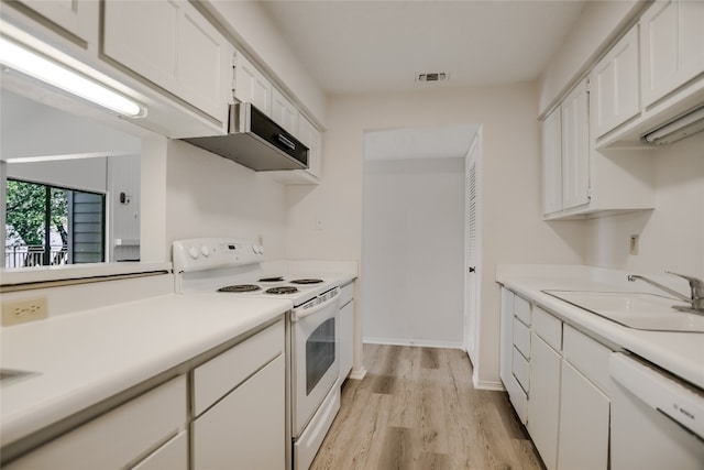 304 Hi There Unit 137, Horseshoe Bay, TX 78657 - kitchen featuring white appliances, wall chimney range hood, light wood-style floors, white cabinetry, and light countertops