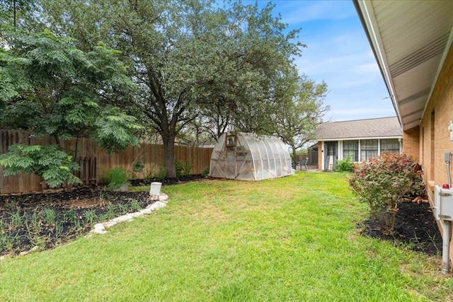 3704 Austin Cv, Lago Vista, TX 78645 - fenced backyard featuring a greenhouse and an outdoor structure