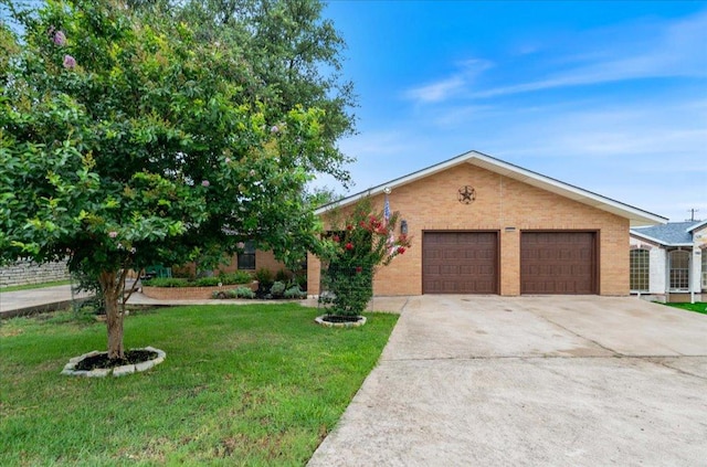 3704 Austin Cv, Lago Vista, TX 78645 - view of front of property with a front lawn, driveway, a garage, and brick siding
