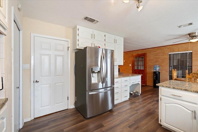 3704 Austin Cv, Lago Vista, TX 78645 - kitchen featuring stainless steel fridge with ice dispenser, white cabinets, dark wood-type flooring, a ceiling fan, and light stone countertops