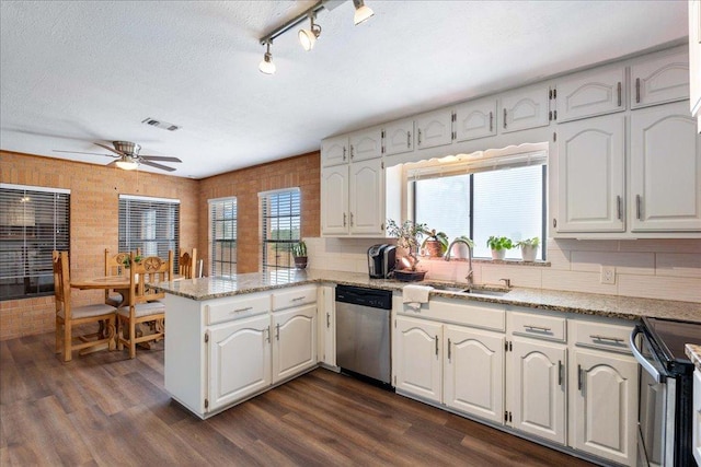 3704 Austin Cv, Lago Vista, TX 78645 - kitchen with dishwasher, a peninsula, ceiling fan, dark wood-style floors, and range with electric cooktop