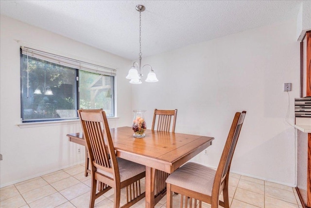 1321 Warrington Dr, Austin, TX 78753 - dining space with a chandelier, light tile patterned floors, and a textured ceiling