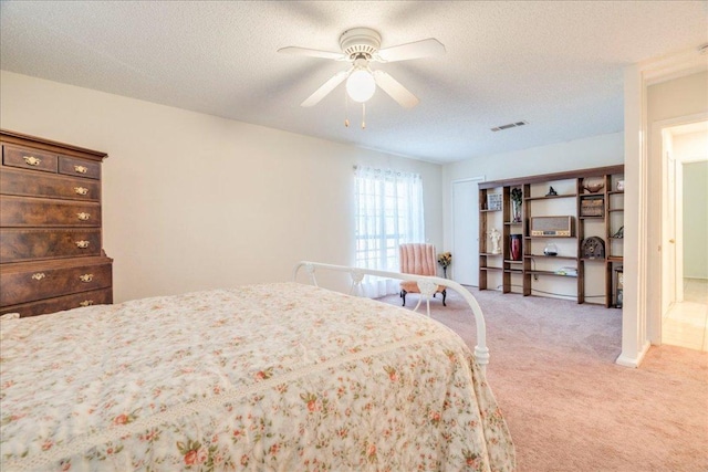 1321 Warrington Dr, Austin, TX 78753 - bedroom with light carpet, a ceiling fan, and a textured ceiling