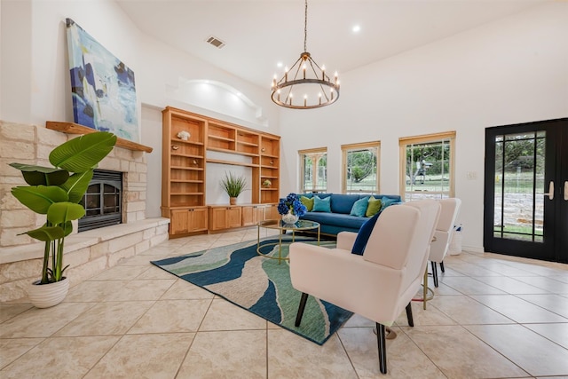211 E Creek Dr, Dripping Springs, TX 78620 - living area featuring light tile patterned floors, a chandelier, a high ceiling, a fireplace, and recessed lighting