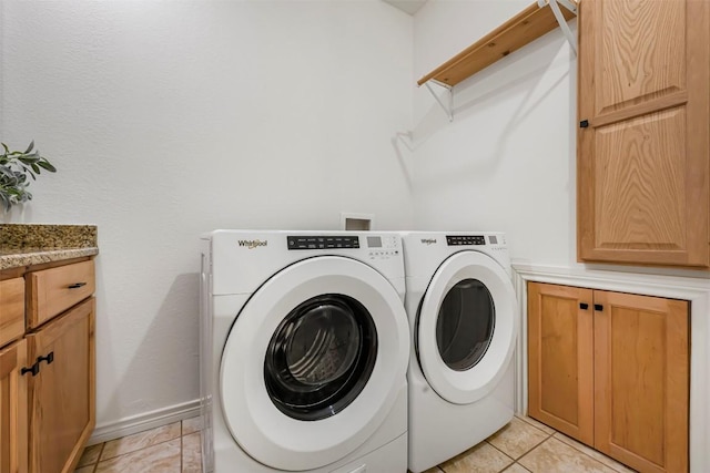211 E Creek Dr, Dripping Springs, TX 78620 - laundry room featuring washing machine and clothes dryer, cabinet space, and light tile patterned flooring