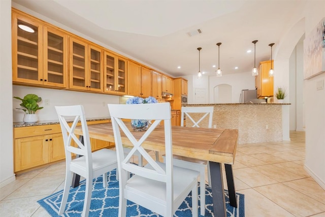 211 E Creek Dr, Dripping Springs, TX 78620 - dining area with light tile patterned flooring, arched walkways, and recessed lighting