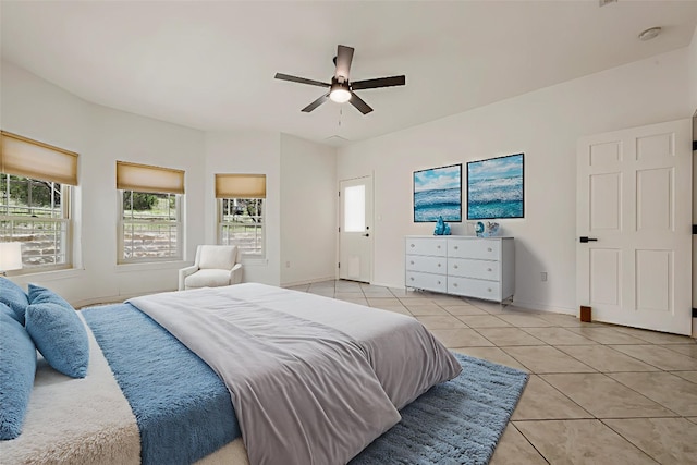 211 E Creek Dr, Dripping Springs, TX 78620 - bedroom with light tile patterned floors, multiple windows, and a ceiling fan