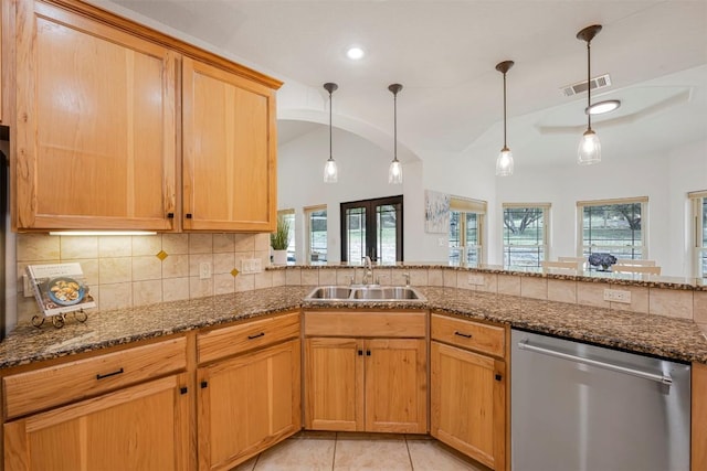 211 E Creek Dr, Dripping Springs, TX 78620 - kitchen featuring stainless steel dishwasher, dark stone countertops, decorative backsplash, healthy amount of natural light, and vaulted ceiling