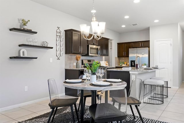 2010 Grow Ln, Austin, TX 78754 - dining area featuring light tile patterned flooring, recessed lighting, and a chandelier