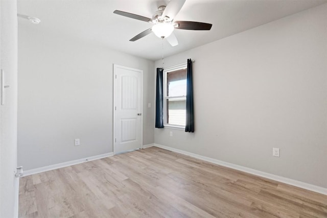 2010 Grow Ln, Austin, TX 78754 - unfurnished room with light wood-style floors, a ceiling fan, and a smoke detector