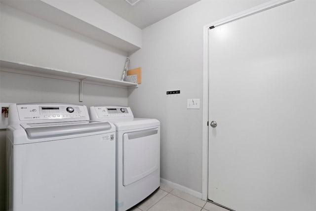 2010 Grow Ln, Austin, TX 78754 - washroom featuring separate washer and dryer and light tile patterned floors