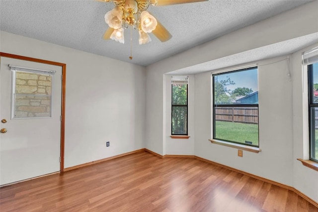 209 Lenz St, Round Rock, TX 78681 - empty room with wood finished floors, a textured ceiling, and a ceiling fan