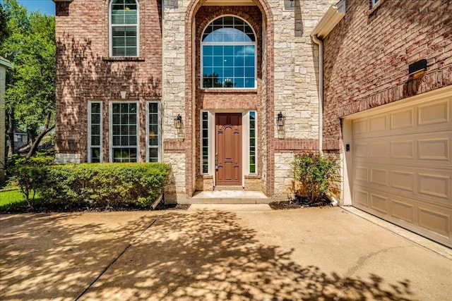 2804 Forest Green Dr, Round Rock, TX 78665 - doorway to property with driveway, stone siding, brick siding, and a garage