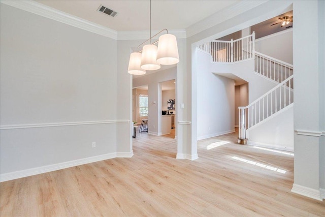 2804 Forest Green Dr, Round Rock, TX 78665 - unfurnished dining area featuring stairs, wood finished floors, crown molding, and a high ceiling
