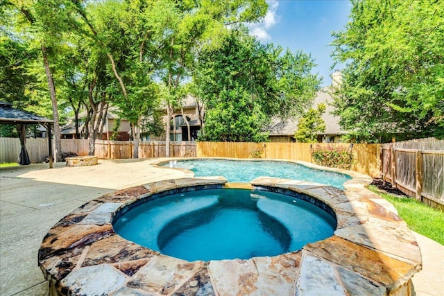 2804 Forest Green Dr, Round Rock, TX 78665 - view of pool featuring a patio area, a pool with connected hot tub, a fenced backyard, and a gazebo