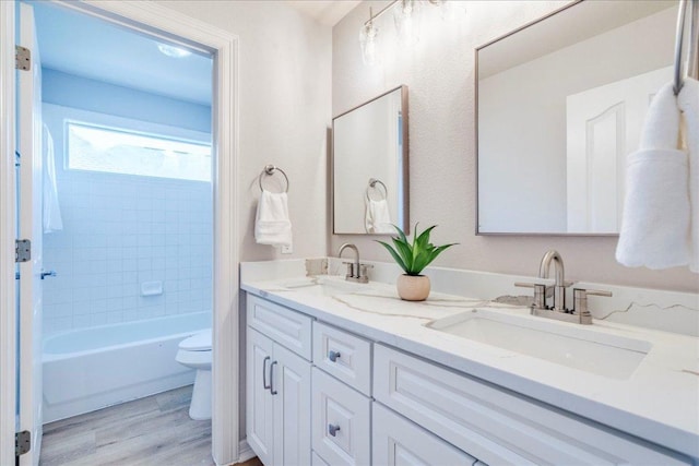 2804 Forest Green Dr, Round Rock, TX 78665 - full bathroom featuring double vanity, wood finished floors, and shower / tub combination