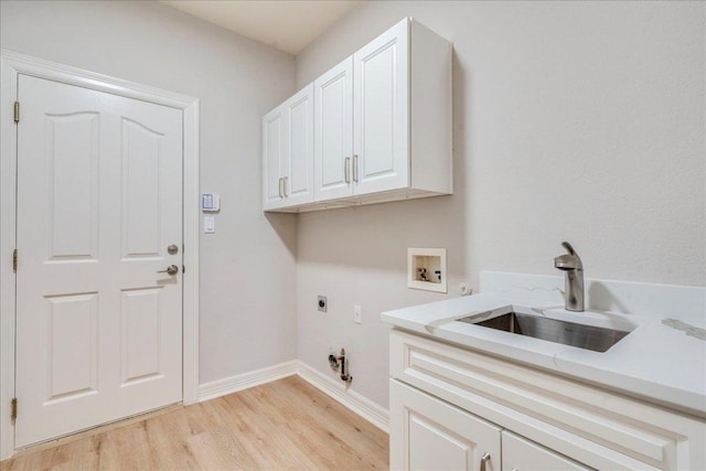 2804 Forest Green Dr, Round Rock, TX 78665 - laundry room featuring cabinet space, electric dryer hookup, hookup for a washing machine, light wood-style floors, and gas dryer hookup
