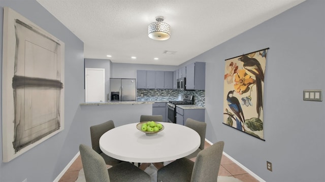 12307 Emery Oaks Rd, Austin, TX 78758 - dining area featuring light tile patterned flooring, a textured ceiling, and recessed lighting