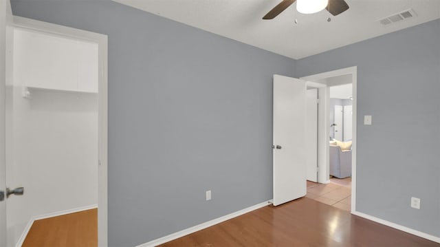 12307 Emery Oaks Rd, Austin, TX 78758 - unfurnished bedroom featuring wood finished floors and ceiling fan