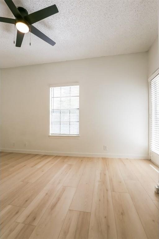 203 E 31st St Unit 206, Austin, TX 78705 - empty room featuring a textured ceiling, light wood-style floors, and ceiling fan