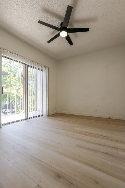 203 E 31st St Unit 206, Austin, TX 78705 - unfurnished room with a textured ceiling, ceiling fan, and light wood-style floors
