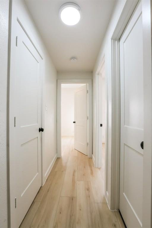 203 E 31st St Unit 206, Austin, TX 78705 - hallway featuring light wood-type flooring and baseboards