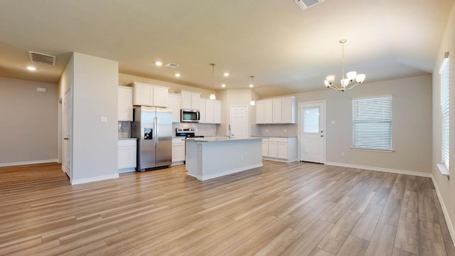 600 Sydney Blvd, Thorndale, TX 76577 - kitchen featuring stainless steel appliances, open floor plan, white cabinets, light wood-style floors, and recessed lighting