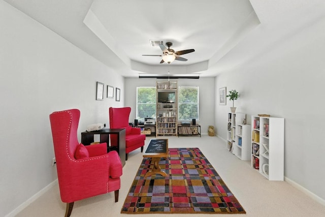 12532 Labrador Cv, Austin, TX 78729 - carpeted living area featuring a ceiling fan and a tray ceiling