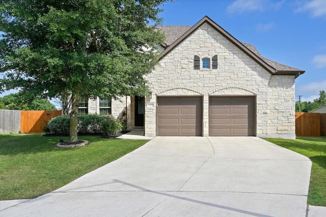 21506 Greylag Dr, Pflugerville, TX 78660 - french country style house featuring stone siding, driveway, and a garage
