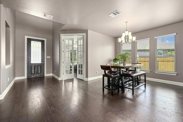 21506 Greylag Dr, Pflugerville, TX 78660 - dining area with a chandelier, wood finished floors, and a textured ceiling