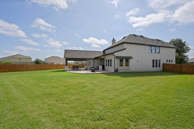 21506 Greylag Dr, Pflugerville, TX 78660 - rear view of property featuring stone siding, a fenced backyard, a patio area, and a chimney