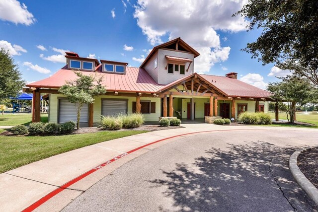 21506 Greylag Dr, Pflugerville, TX 78660 - view of front of property featuring covered porch, a front lawn, and a metal roof