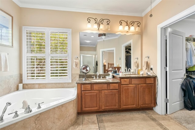 207 Breezeway Ln, Georgetown, TX 78633 - bathroom featuring a ceiling fan, a stall shower, crown molding, a spacious closet, and double vanity