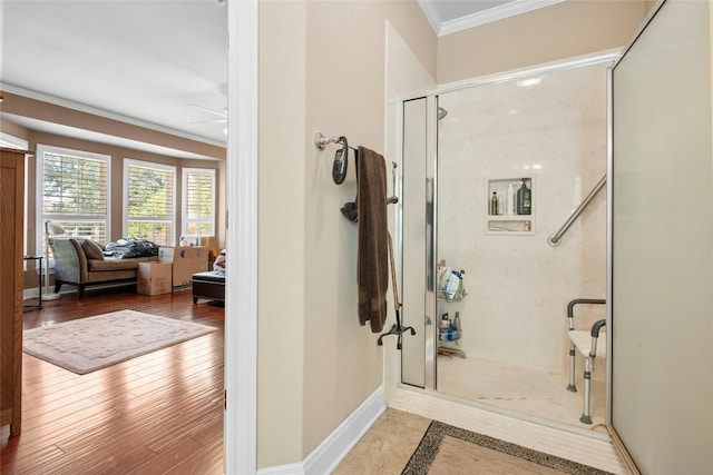 207 Breezeway Ln, Georgetown, TX 78633 - full bathroom featuring ornamental molding, a shower stall, ceiling fan, and wood finished floors