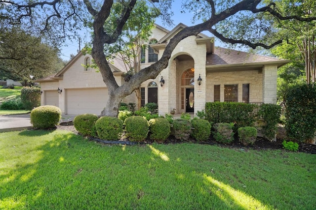 10303 Spicewood Pkwy, Austin, TX 78750 - traditional-style home featuring stone siding, a front lawn, and a garage
