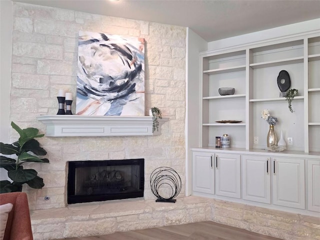 10303 Spicewood Pkwy, Austin, TX 78750 - living area with a stone fireplace, wood finished floors, and built in features