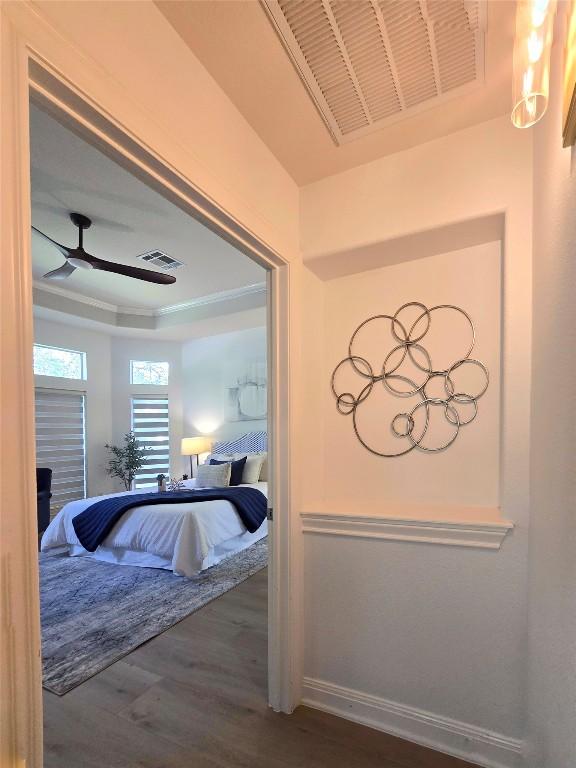 10303 Spicewood Pkwy, Austin, TX 78750 - bedroom with wood finished floors and a raised ceiling