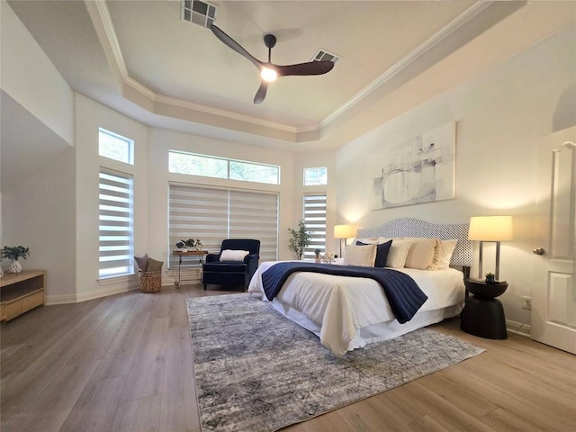 10303 Spicewood Pkwy, Austin, TX 78750 - bedroom with a tray ceiling, ornamental molding, wood finished floors, and a ceiling fan