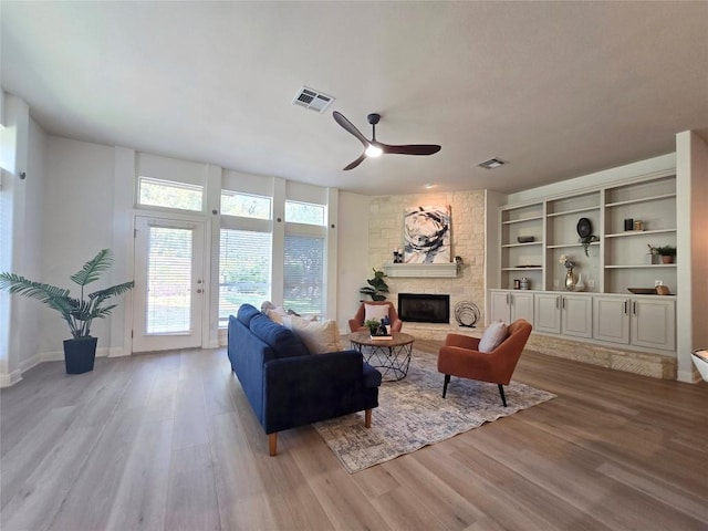 10303 Spicewood Pkwy, Austin, TX 78750 - living area with a ceiling fan, wood finished floors, and a fireplace