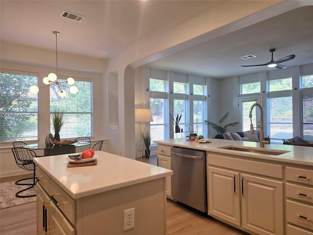 10303 Spicewood Pkwy, Austin, TX 78750 - kitchen featuring dishwasher, light wood-type flooring, open floor plan, light countertops, and a kitchen island